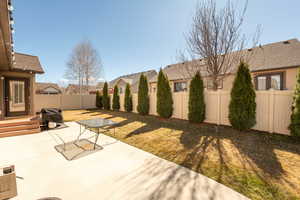 Fenced backyard with a patio and a residential view