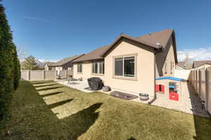 Rear view of house with a patio area, stucco siding, a fenced backyard, and a shingled roof