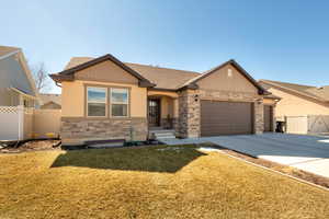 Craftsman house featuring a gate, an attached garage, concrete driveway, stone siding, and a shingled roof