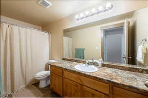 Bathroom with curtained shower, vanity, and a textured ceiling