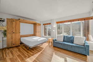 Bedroom featuring light wood-style floors and baseboards