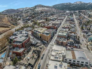 Aerial overview of property's location featuring a mountainous background