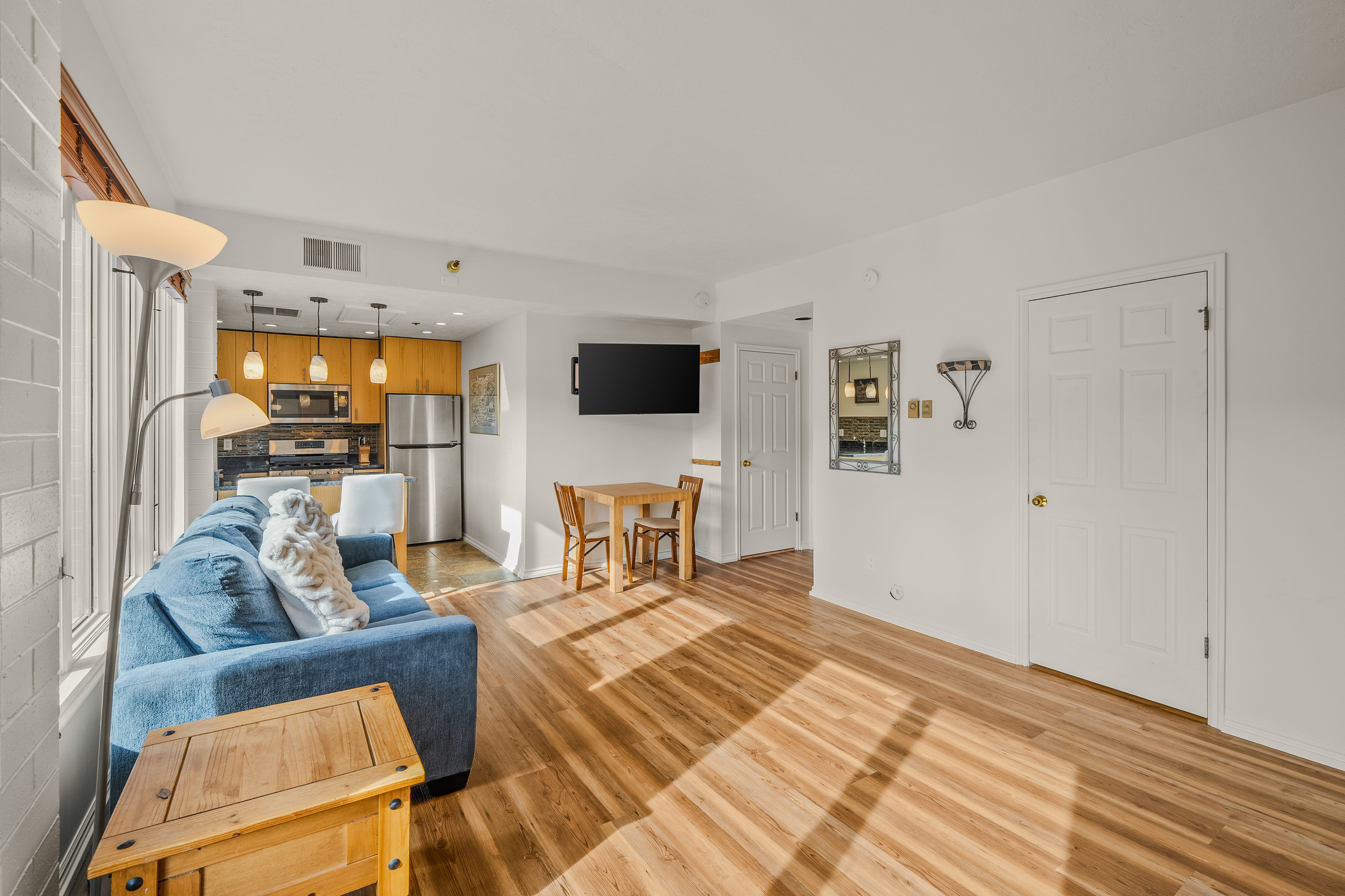 Living area with light wood-style flooring and baseboards