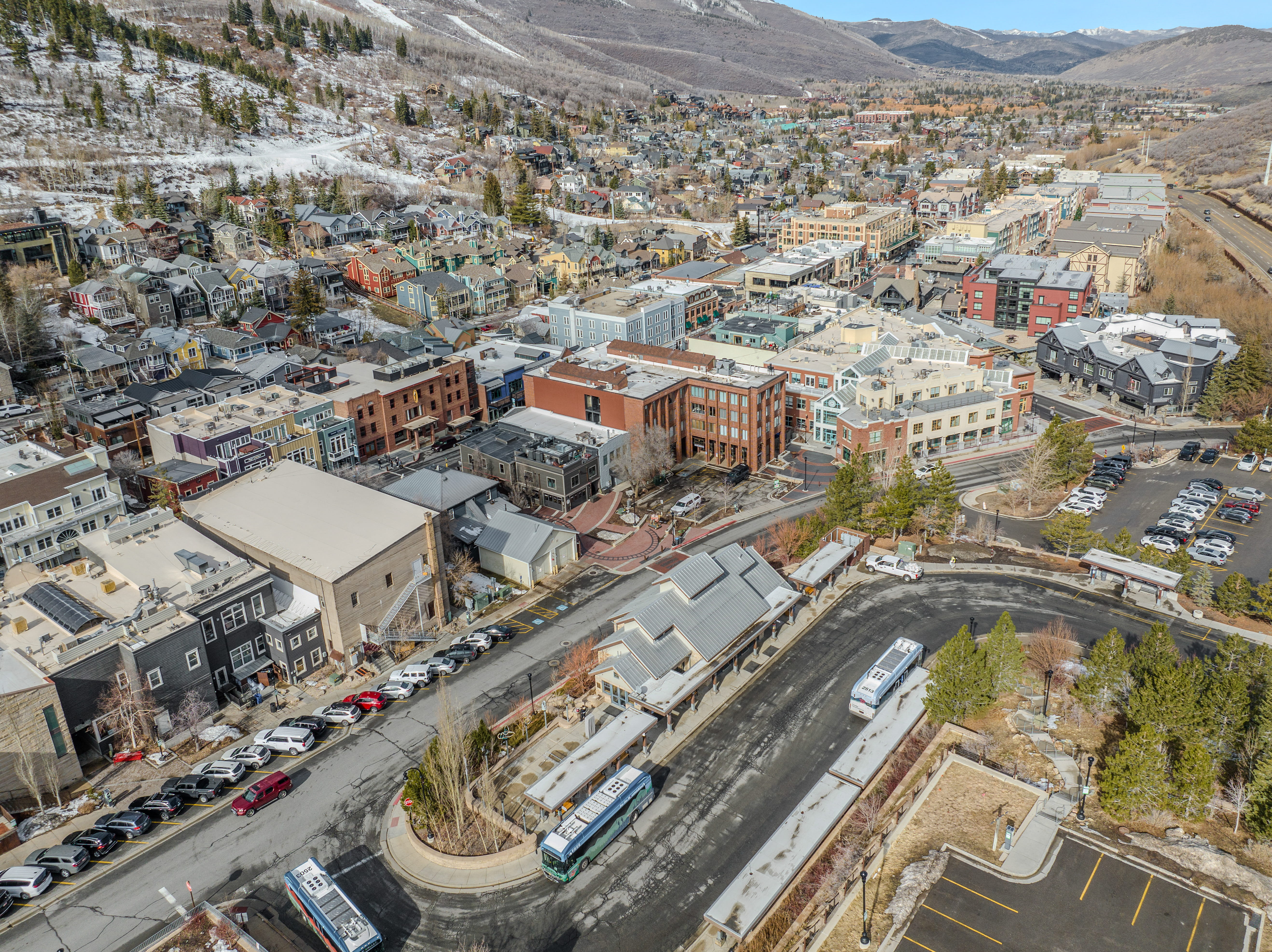 Aerial view of property and surrounding area with a mountain backdrop