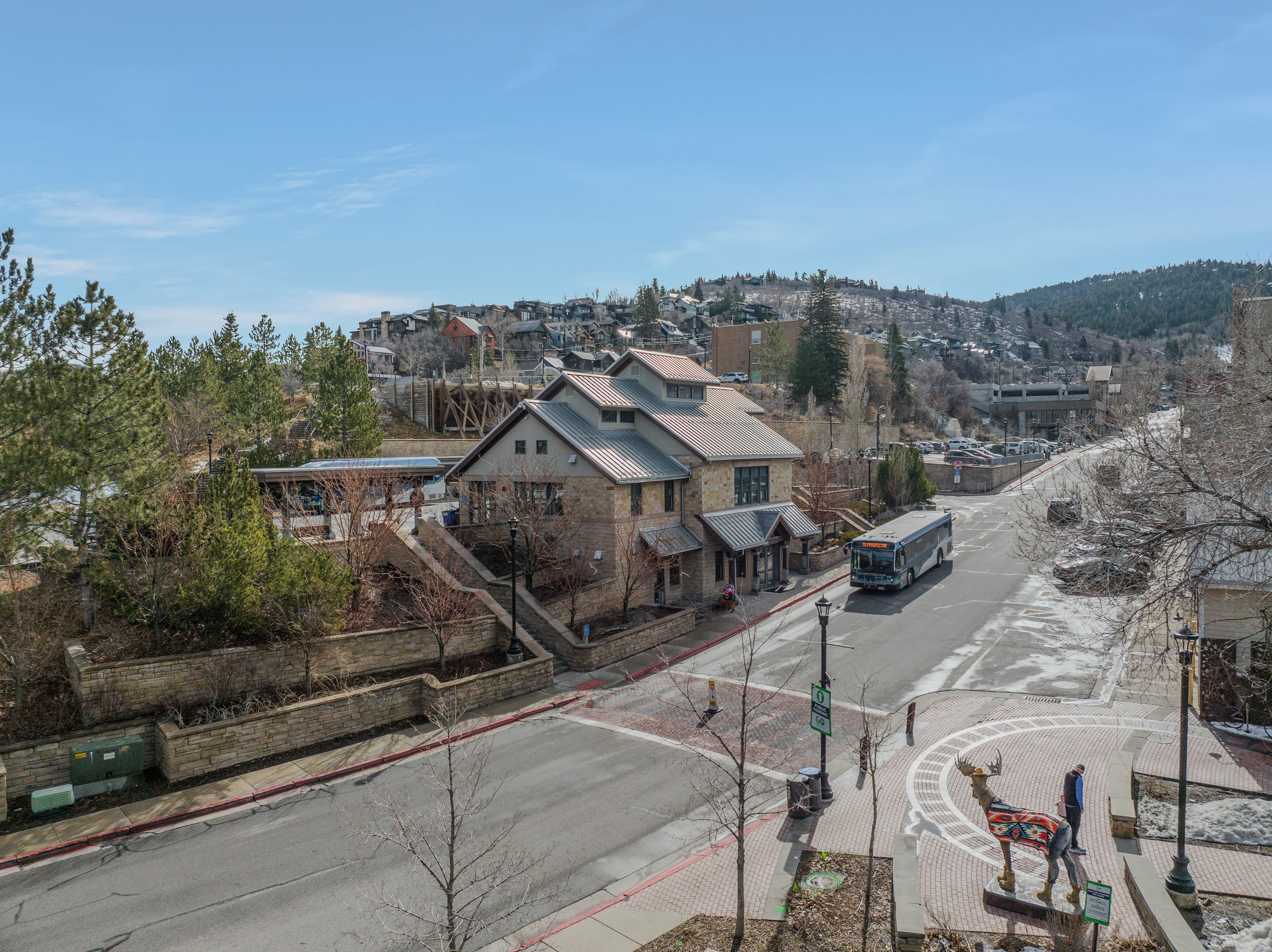 View of asphalt road featuring sidewalks and curbs