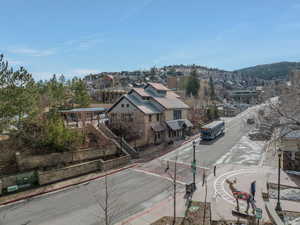 View of asphalt road featuring sidewalks and curbs