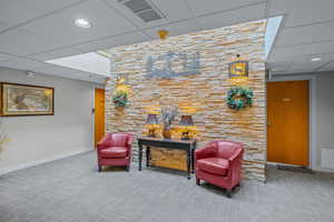 Community lobby with a paneled ceiling and recessed lighting