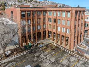 View of apartment building / complex with a mountain view and uncovered parking
