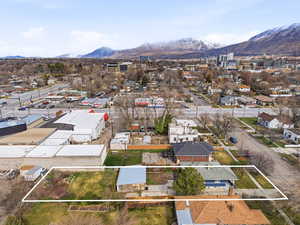 Aerial view of residential area with property boundaries highlighted and mountains