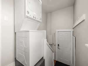 Laundry room featuring stacked washer / dryer for the upstairs unit.