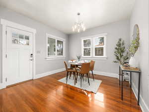 Dining room with hardwood / wood-style flooring and hanging lights