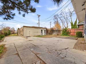 Large parking area behind the home with a large shed that could be turned into a detached garage