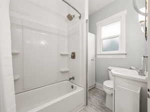 Bathroom with shower / bath combo with shower curtain and vanity
