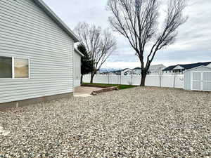 View of yard with a storage unit