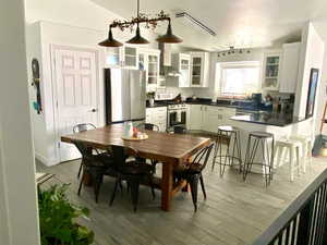 Dining space with lofted ceiling