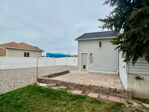 Fenced backyard with a patio