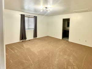 Master Bedroom with carpet flooring and a textured ceiling