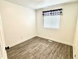 Unfurnished room featuring tiled floors and a textured ceiling
