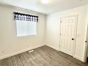 Empty room featuring tiled floors and a textured ceiling