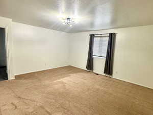 Master Bedroom featuring carpet flooring and a textured ceiling