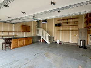 Garage featuring a garage door opener and epoxied floor