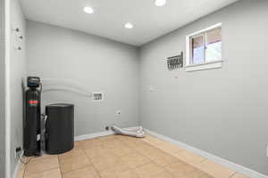 Laundry room featuring washer hookup, light tile patterned floors, gas dryer hookup, and recessed lighting