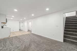 Below grade area with recessed lighting and light carpet