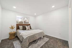 Bedroom featuring dark colored carpet and recessed lighting