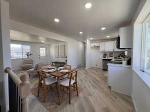 Dining space featuring recessed lighting, light wood-style flooring, and a textured ceiling