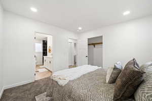 Carpeted bedroom with a closet, ensuite bath, and recessed lighting