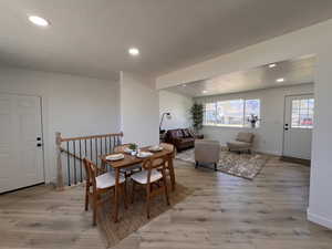 Dining room with recessed lighting, a textured ceiling, and light wood-style flooring