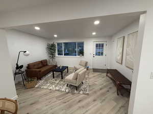 Living area featuring light wood-style floors and recessed lighting