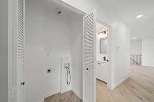 Laundry area with hookup for a washing machine, light wood-style floors, recessed lighting, and electric dryer hookup