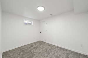 Below grade area featuring baseboards and carpet floors