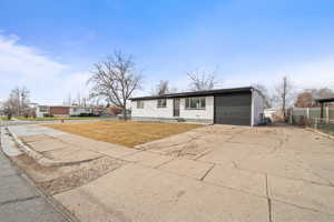 Single story home featuring driveway and an attached garage