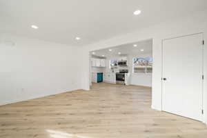 Unfurnished living room with light wood-style floors and recessed lighting