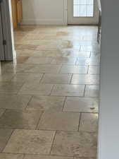 Detailed view of luxurious travertine floors throughout