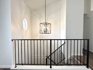 Detailed view of wood finished floors and a chandelier