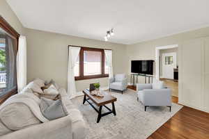 Living area with wood finished floors and baseboards