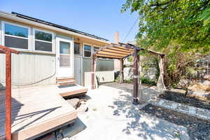 Fenced backyard featuring a deck and a gazebo