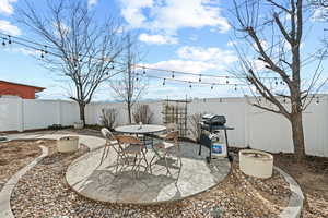 Fenced backyard featuring a patio area, area for grilling, and outdoor dining area