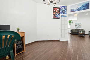 Office featuring wood tiled floors and a chandelier