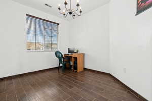 Unfurnished office featuring hanging lights and wood tiled floors