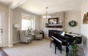 Sitting room featuring crown molding, light carpet, and a fireplace