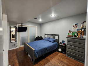 Bedroom featuring dark wood-type flooring and a textured ceiling