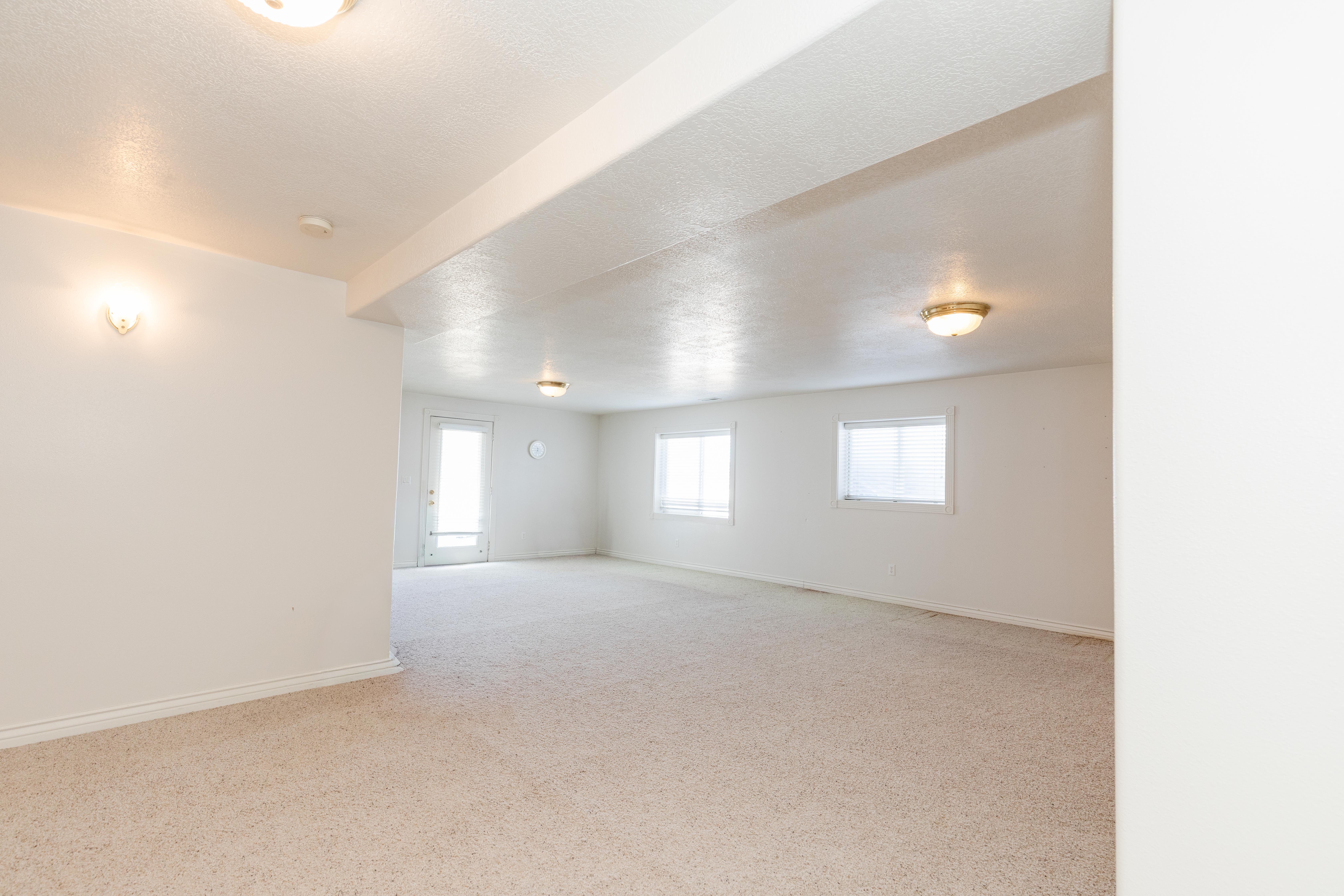 Unfurnished room with light colored carpet and a textured ceiling