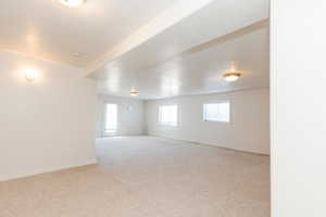 Unfurnished room with light colored carpet and a textured ceiling