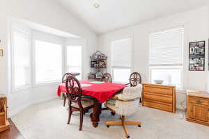 Dining area featuring vaulted ceiling, carpet floors, and recessed lighting