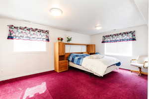 Carpeted bedroom featuring baseboards