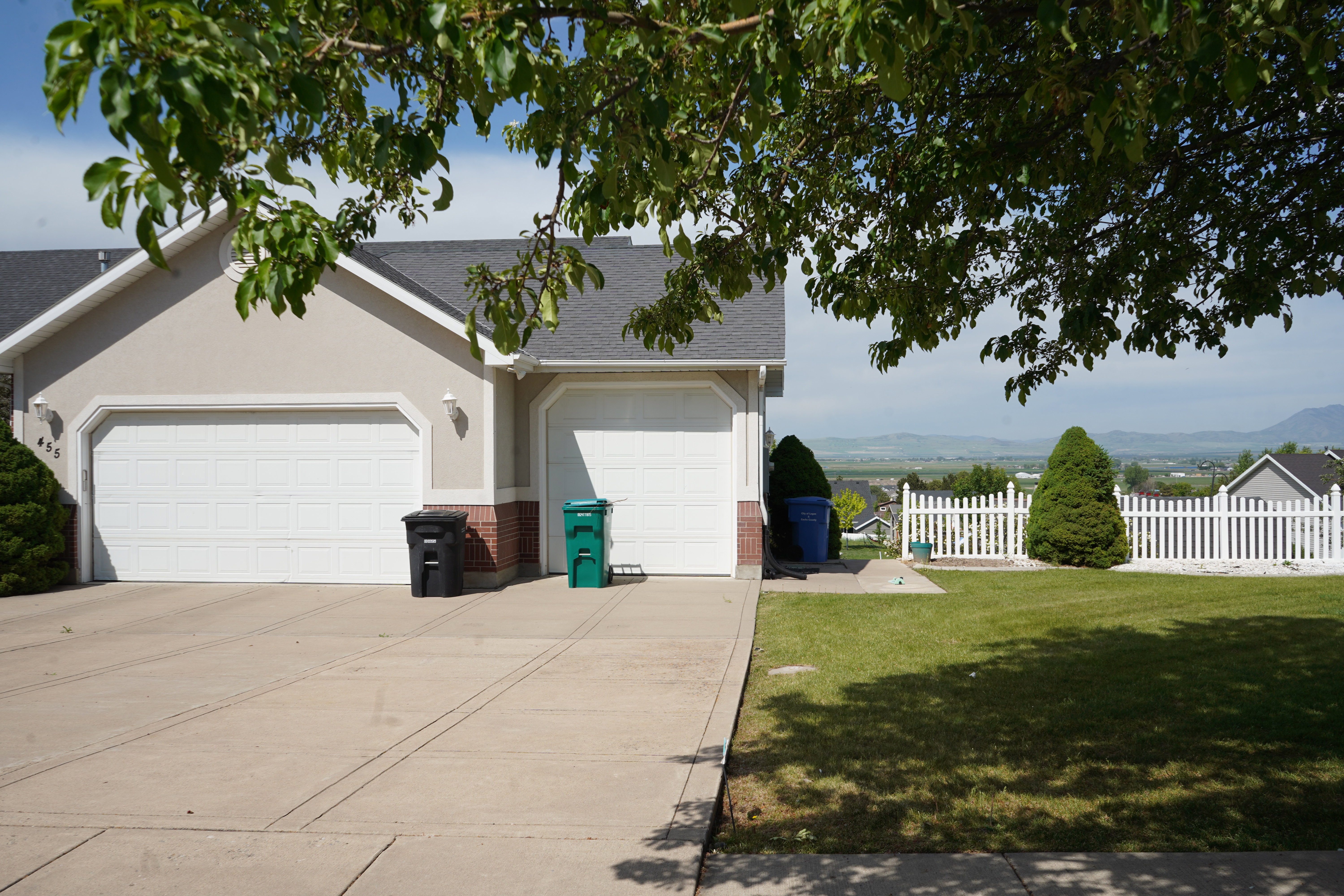 Stucco exterior with a two-car garage and a paved driveway